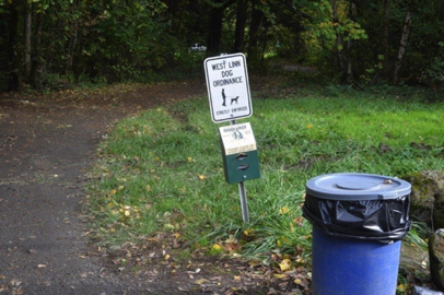 Dog rules and disposal bags at the entry of the Trillium natural surface trail